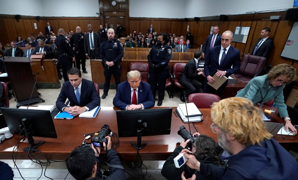 Former US President Donald Trump, with lawyer Todd Blanche, attends his trial for allegedly covering up hush money payments linked to extramarital affairs, at Manhattan Criminal Court in New York City on April 23, 2024. — Pool via Reuters pic