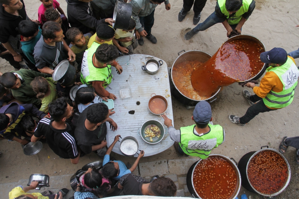 Volunteers deliver food to families, amid the ongoing conflict between Israel and the Palestinian Islamist group Hamas, in Jabalia, in the northern Gaza Strip April 22, 2024. — Reuters pic