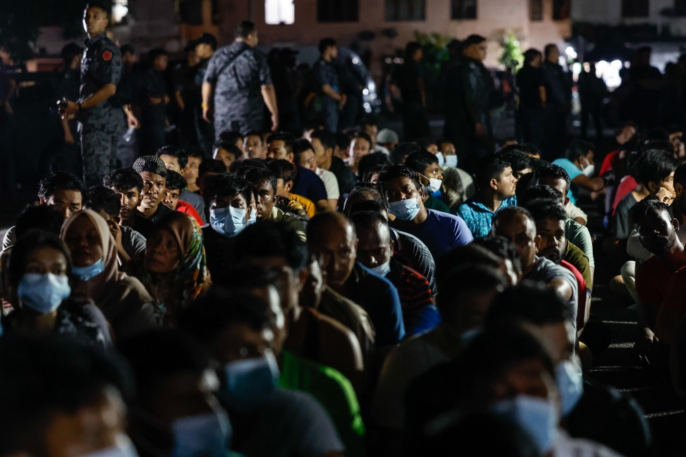Undocumented immigrants are gathered up during a raid by the Immigration Department at the Baiduri Apartment, Taman Tasik Kesuma Beranang, Semenyih January 19, 2024. — Bernama pic