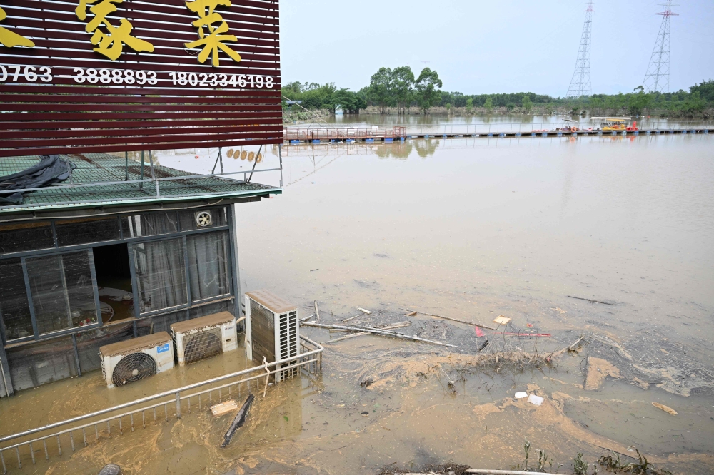 A general view shows a damaged restaurant next to a small pond after torrential rains flooded the area in Qingyuan. — AFP pic