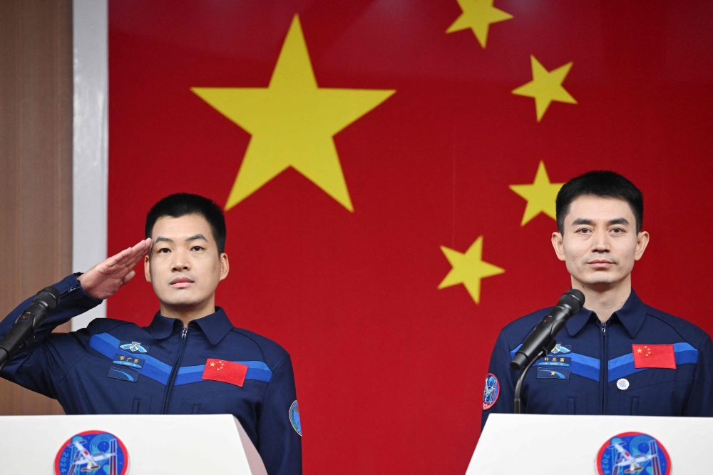 Astronauts Li Guangsu (left) and Ye Guangfu attend a press conference a day before the launch of the mission, at the Jiuquan Satellite Launch Centre in the Gobi desert. — AFP pic