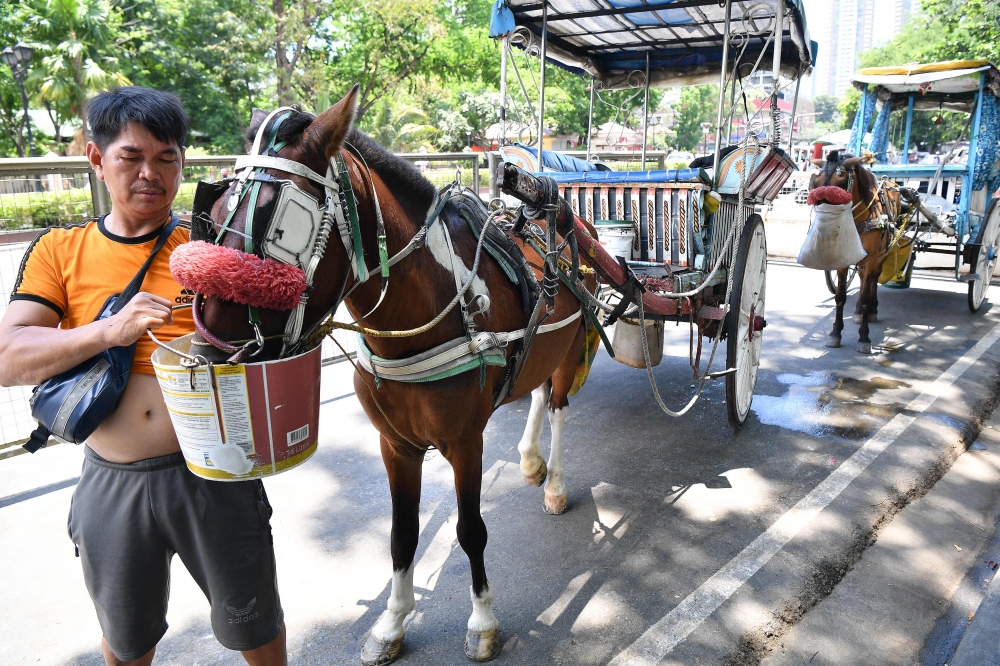 Extreme heat scorched the Philippines today, forcing schools in some areas to suspend in-person classes and prompting warnings for people to limit the amount of time spent outdoors. — AFP pic