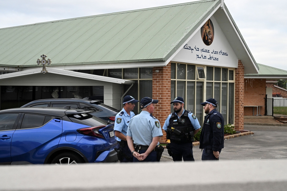 Police officers at the site of the Assyrian Christ The Good Shepherd Church where an Assyrian bishop who was stabbed during a service. — Reuters pic