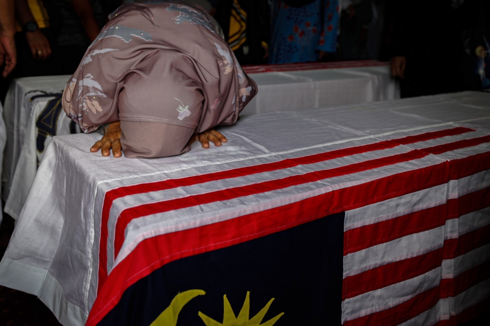 The relatives of the victims of the helicopter crash are seen during the funeral ceremony at Surau Salahuddin Al-Ayubi, the 23rd Battalion Camp of the Royal Malay Regiment at the Lumut RMN base April 24, 2024. — Bernama pic
