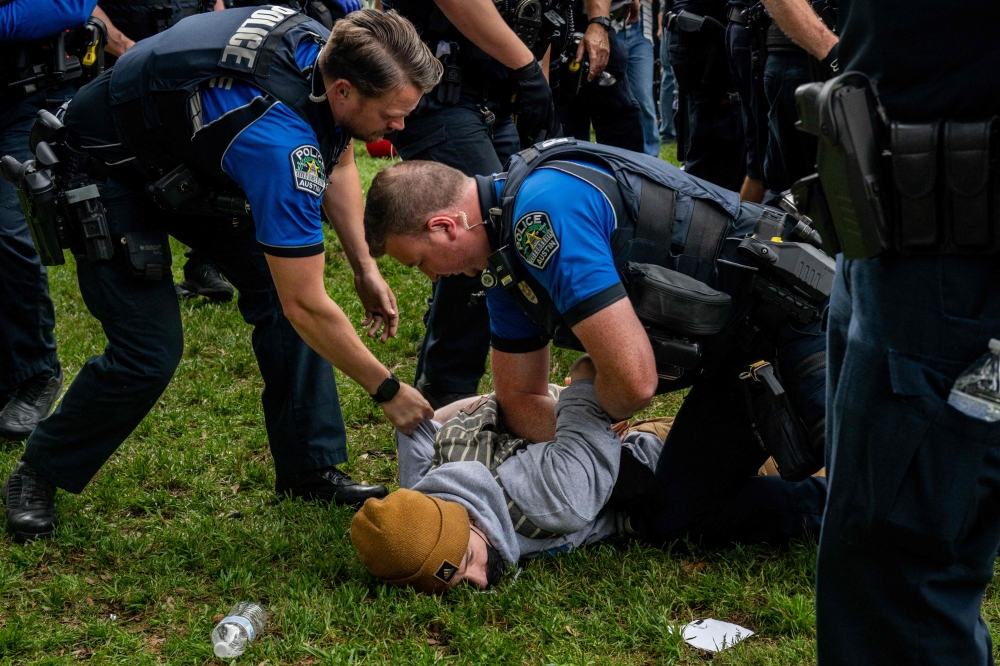 A student is arrested during a pro-Palestine demonstration at the The University of Texas, Austin. — AFP pic