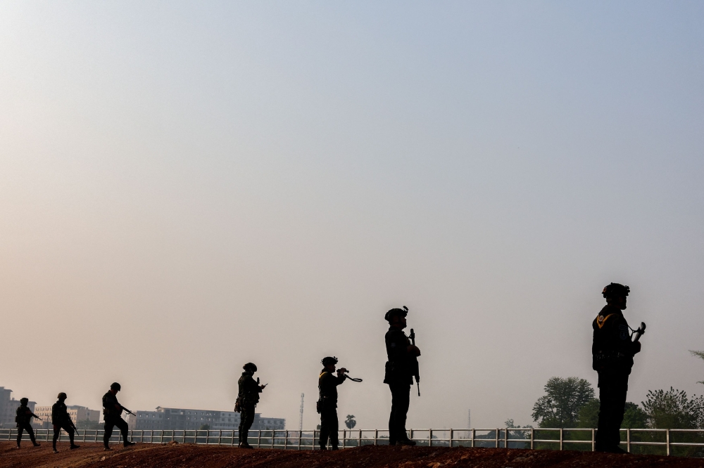 Thai military personnel stand guard at the border between Myanmar and Thailand on Friday following the fall of a strategic border town to rebels fighting Myanmar’s military junta. — Reuters pic
