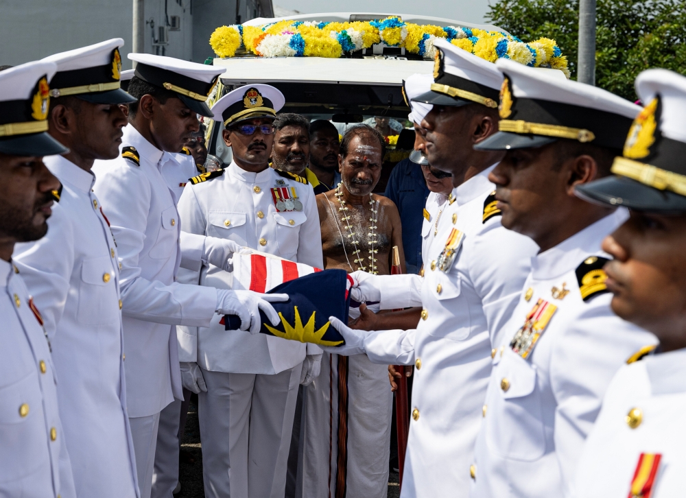 The father of the late Lieutenant T. Sivasutan, M. Thanjappan, 61, (centre) could not contain his grief when Navy personnel perform the ceremony of folding the Ensign Flag (Panji-Panji TLDM) at at his residence in Taman Serdang Jaya in Sitiawan, Manjung, April 25, 2024. — Bernama pic 