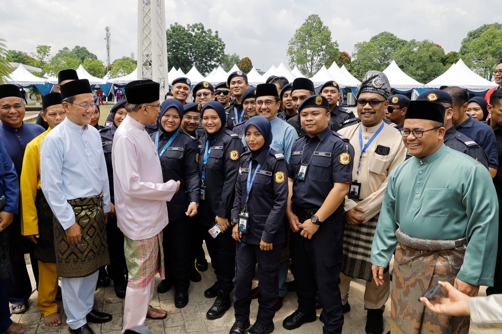 Prime Minister Datuk Seri Anwar Ibrahim chats with the MAB Auxiliary Police team after performing Friday prayers at the Malaysia Airline Berhad (MAB) Islamic Convention Centre at Kuala Lumpur International Airport (KLIA), April 26, 2024. — Bernama pic 