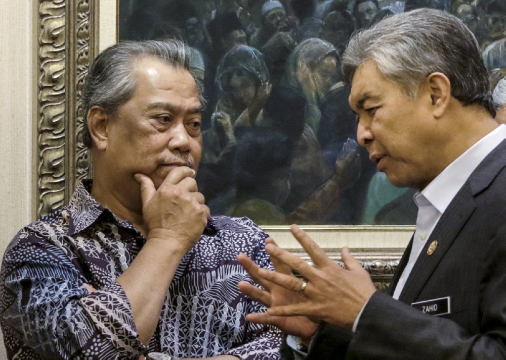 File picture of Tan Sri Muhyiddin Yassin and Datuk Seri Ahmad Zahid Hamidi in Kuala Lumpur, September 9, 2015. In a joint statement today, they said the decision was made after considering the effects that the defamation suit would have on the public as well as the recommendations of the High Court judge. — Reuters pic