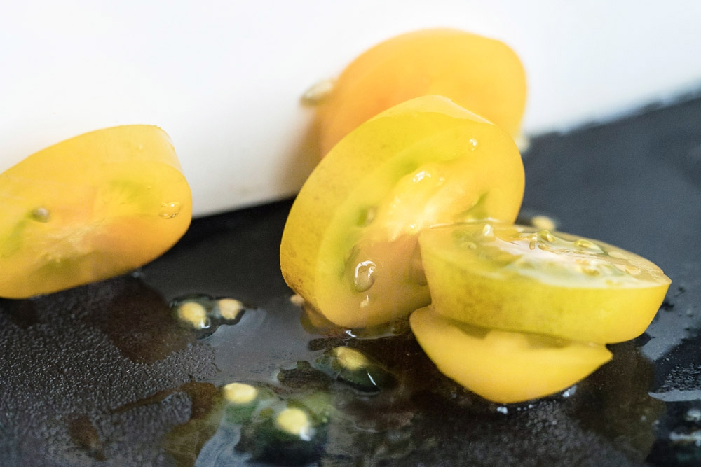 Use a sharp knife to slice the tomatoes.