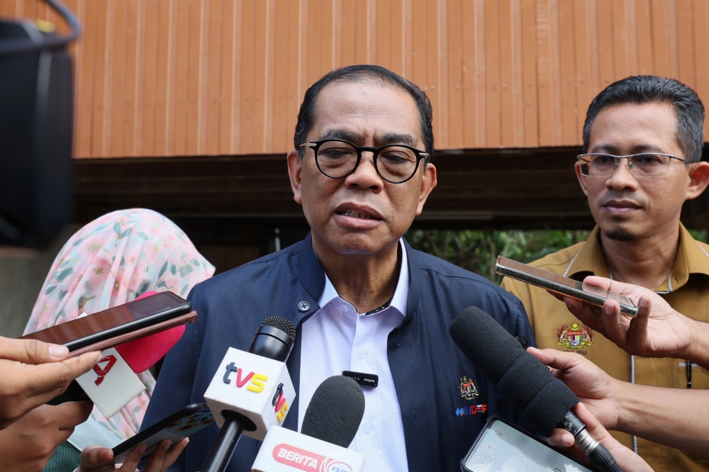 Defence Minister Datuk Seri Mohamed Khaled Nordin speaks to reporters after completing the handover of ‘Rumah Kasih Ihsan’ at Kampung Dusun Tembakau in Manir, Kuala Terengganu April 27, 2024. — Bernama pic