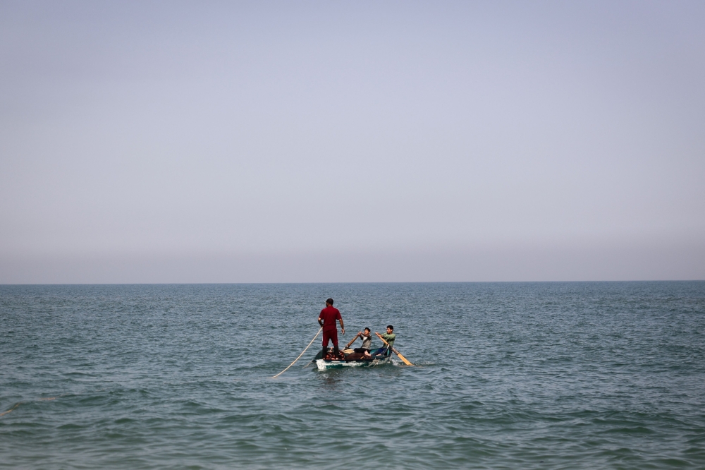 File photo of Palestinian fishermen preparing to pull out their net from the sea at the Rafah shore in the southern Gaza Strip on April 23, 2024, amid the ongoing conflict between Israel and the Palestinian militant group Hamas. — AFP pic