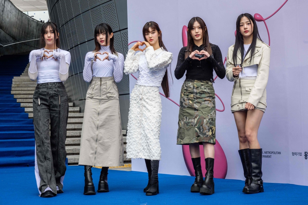 File photo of members of South Korean K-pop group NewJeans posing on the blue carpet at Seoul Fashion Week at Dongdaemun Design Plaza in Seoul on March 15, 2023. — AFP pic