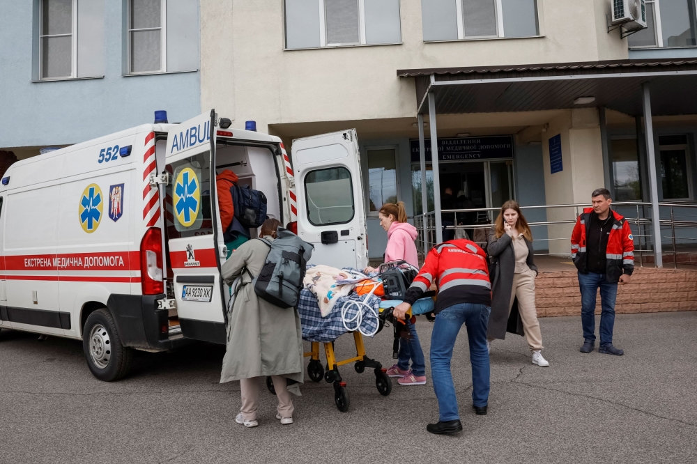 A child is evacuated from a hospital after local authorities declared that there was possible danger of a Russian military strike, amid Russia's attack on Ukraine, in Kyiv, Ukraine, April 26, 2024. — Reuters pic