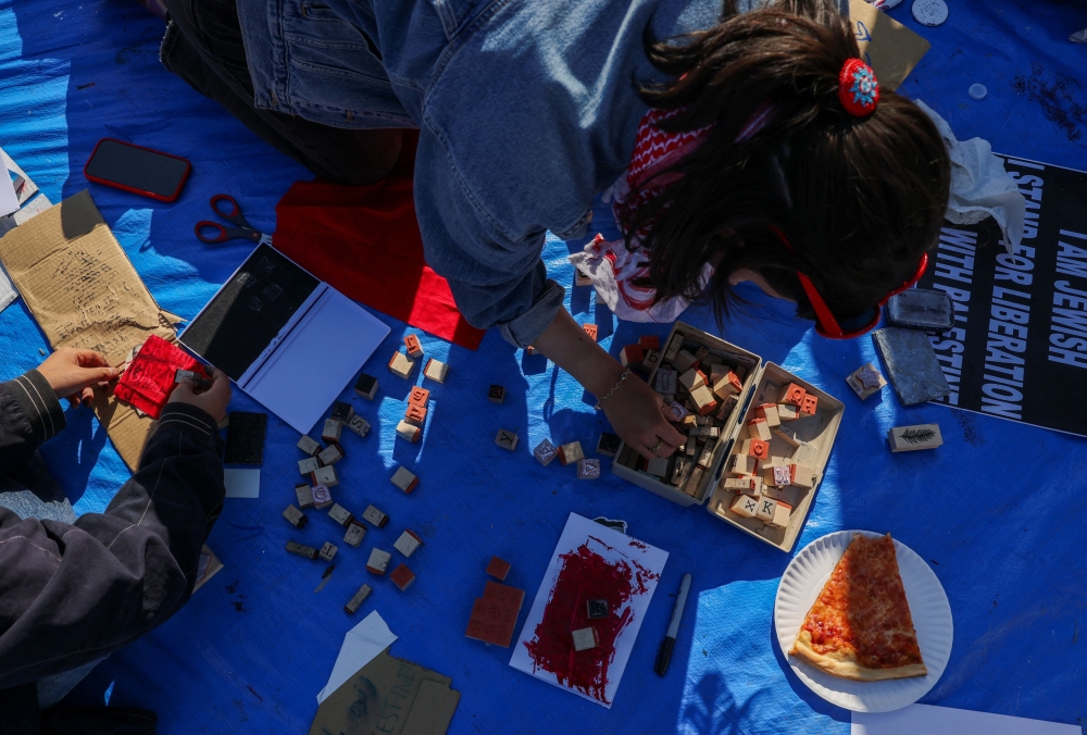 Students make signs as they continue to maintain a protest encampment in support of Palestinians at Columbia University, during the ongoing conflict between Israel and the Palestinian Islamist group Hamas, in New York City, US, April 26, 2024. — Reuters pic