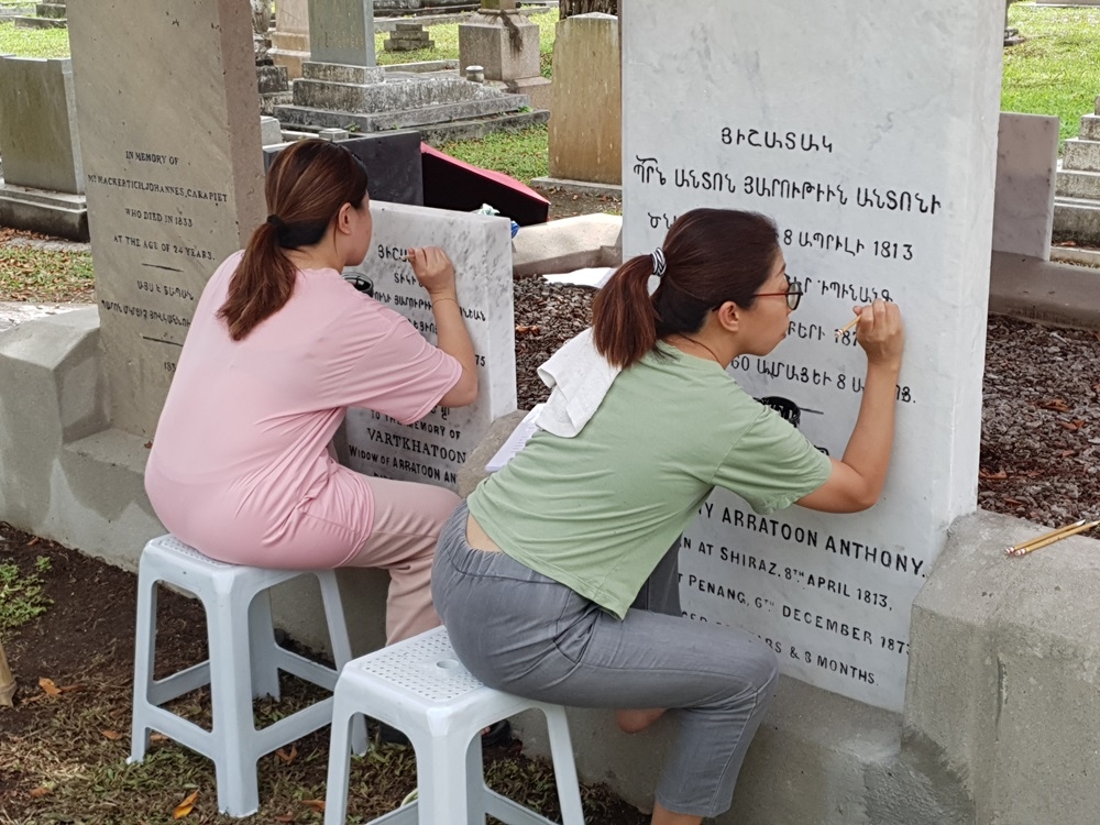Repainting the wordings on the Armenian headstones at the combined plot in Western Road Cemetery. — Picture courtesy of Marcus Langdon