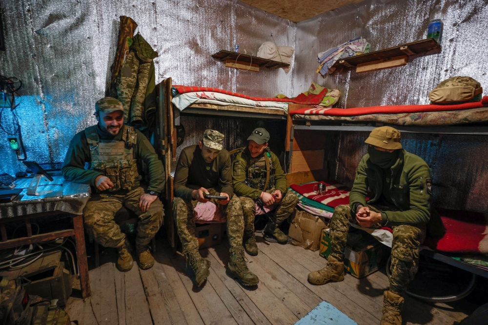 Ukrainian servicemen rest inside a dugout at their position in a front line near the town of Kreminna, amid Russia's attack on Ukraine, in Donetsk region, Ukraine April 25, 2024. — Radio Free Europe/Radio Liberty via Reuters