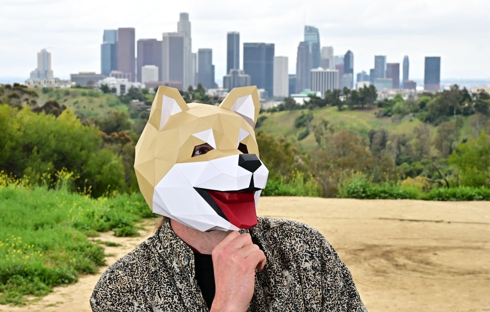 This picture taken on April 4, 2024 shows Tridog, a member of Own the Doge, wearing a Doge mask as he poses for photos during an interview in Los Angeles, California. Own The Doge has brought fans to Japan to meet Kabosu, the shiba inu dog best known as the logo of cryptocurrency Dogecoin. — AFP pic