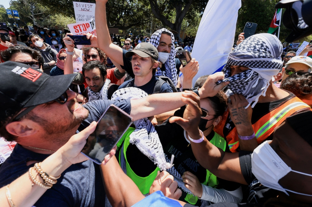 Protesters in support of Palestinians in Gaza and pro-Israel counter-protesters scuffle during demonstrations amid the ongoing conflict between Israel and the Palestinian Islamist group Hamas, at the University of California Los Angeles (UCLA) in Los Angeles, California April 28, 2024. — Reuters pic