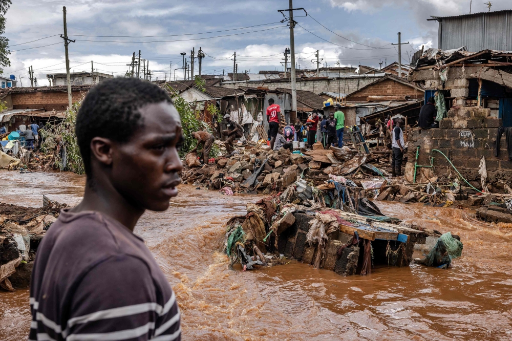 A man stands next to an area were houses were destroyed by floods following torrential rains at the Mathare informal settlement in Nairobi, on April 25, 2024. — AFP pic