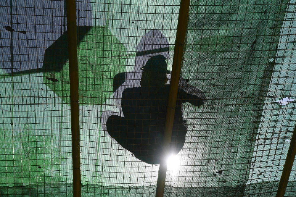 A worker fixes a canopy at a construction site during a heatwave in Manila on April 29, 2024. Unusually hot weather in the Philippines was expected to last until mid-May, a forecaster said April 28, after the temperature hit a record high in the capital Manila. — AFP pic