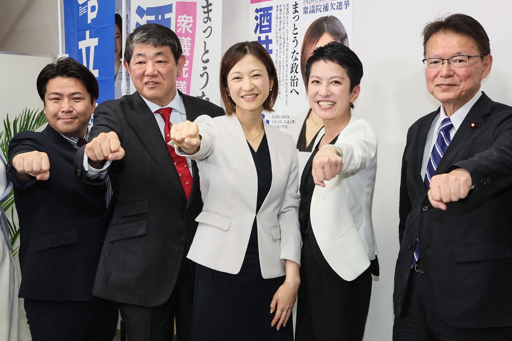 This photo taken on April 28, 2024 shows Natsumi Sakai (centre) of the main opposition Constitutional Democratic Party of Japan posing with others after receiving news that she won the by-election for the Tokyo no. 15 district for the House of Representatives, in Tokyo. Japanese Prime Minister Fumio Kishida faced a further setback after his scandal-hit ruling party yesterday lost three by-elections for national seats. — Jiji Press /AFP pic 