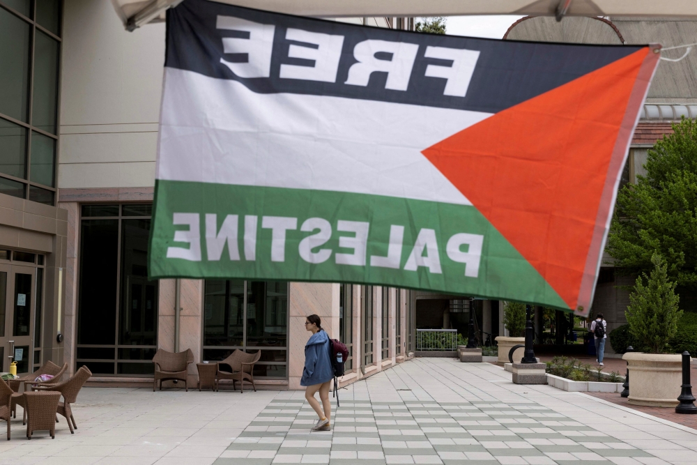 A pro-Palestinian flag is displayed, as students and visitors walk through Emory University’s campus the day after a student protest encampment in support of Palestine ended in arrests during the ongoing conflict between Israel and the Palestinian Islamist group Hamas, in Atlanta, Georgia April 26, 2024. — Reuters pic  