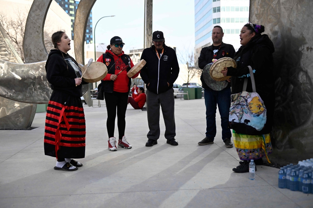 Relatives and friends of late Marcedes Myran gather for a candlelight vigil in front of Manitoba's highest trial court in Winnipeg, Manitoba, on April 28, 2024, on the eve of the trial of the accused. — AFP pic