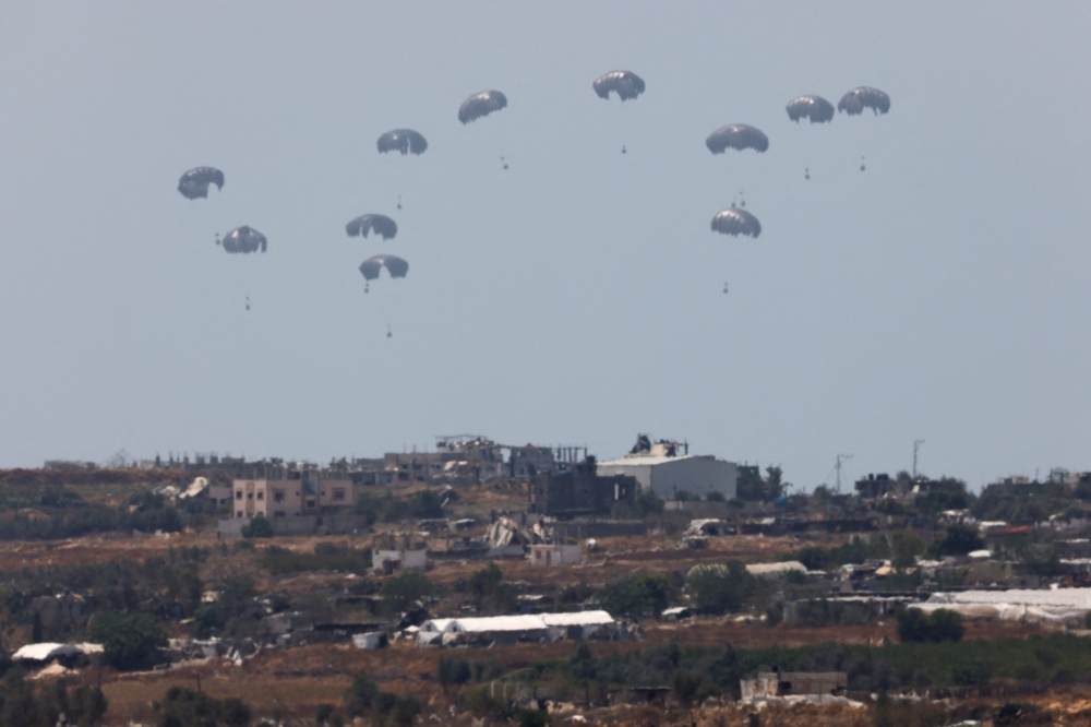 Humanitarian aid falls through the sky towards the Gaza Strip, after being dropped from an aircraft, amid the ongoing conflict between Israel and the Palestinian Islamist group Hamas, as seen from Israel, April 30, 2024. — Reuters pic