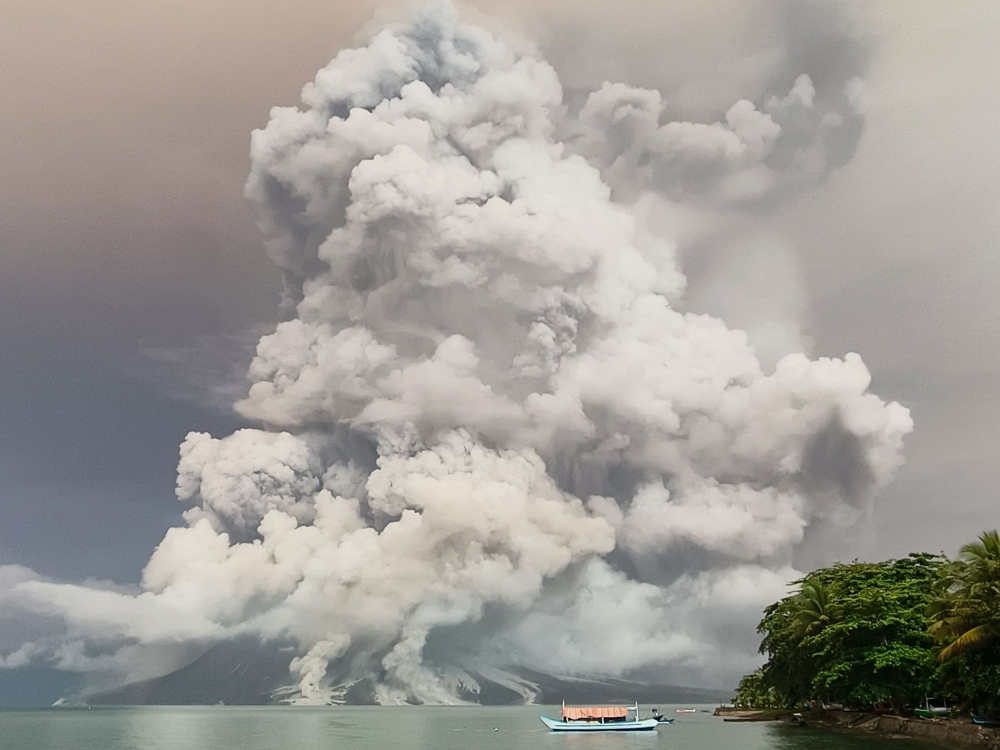 Eruptions at a remote Indonesian volcano forced more than half a dozen airports to close with ash spreading as far as Malaysia, officials said today, while authorities rushed to evacuate thousands due to tsunami fears. — AFP pic