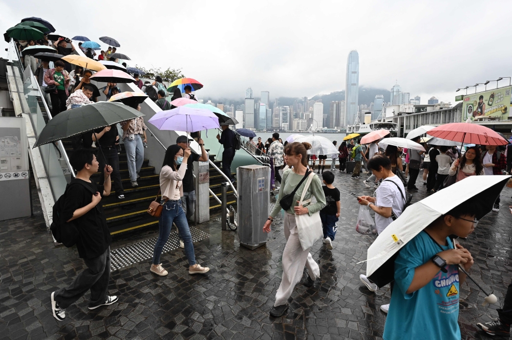 Tourists from mainland China visit the Tsim Sha Tsui waterfront in Hong Kong on May 1, 2024 at the start of the Golden Week holiday period. — AFP pic