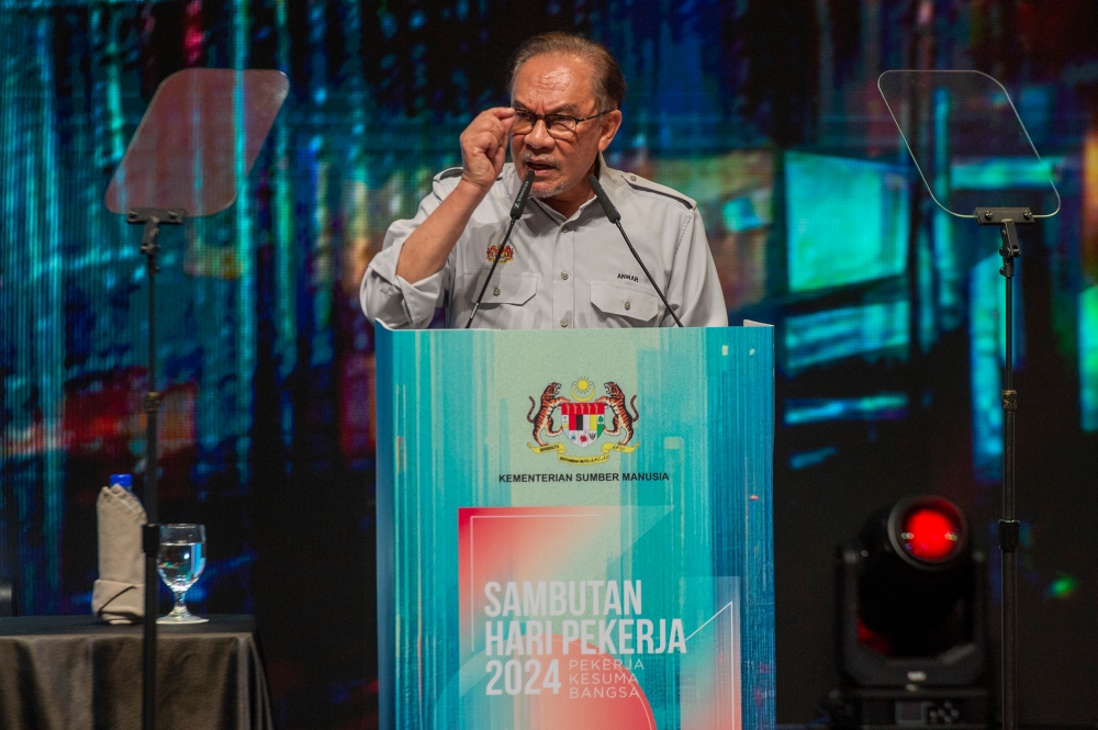 Prime Minister Datuk Seri Anwar Ibrahim delivers a speech at the 2024 Labour Day celebration in Putrajaya May 1, 2024. — Picture by Shafwan Zaidon