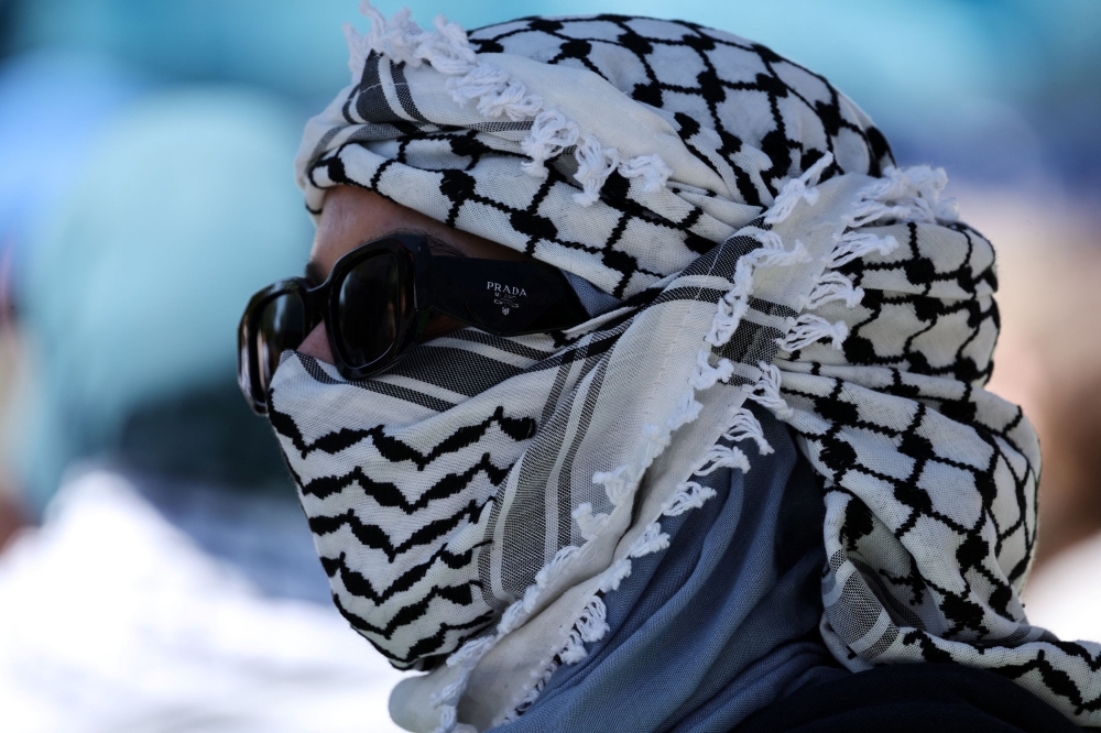 A person wears a scarf around their head as protesters gather at an encampment in support of Palestinians in Gaza, on the campus of the University of California, Irvine, as the conflict between Israel and the Palestinian Islamist group Hamas continues, in Irvine, California, April 30, 2024. — Reuters pic