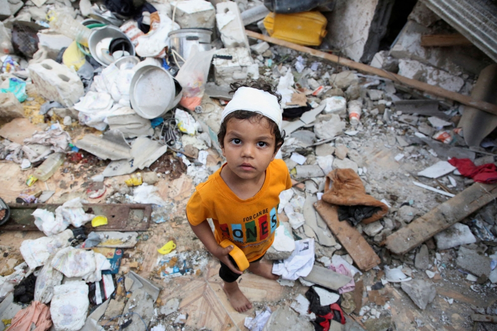 A wounded Palestinian boy reacts at the site of an Israeli strike on a house, amid the ongoing conflict between Israel and the Palestinian Islamist group Hamas, in Rafah, in the southern Gaza Strip, May 1, 2024. — Reuters pic