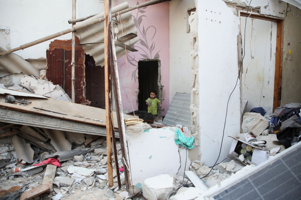 A Palestinian child walks at the site of an Israeli strike on a house, amid the ongoing conflict between Israel and the Palestinian Islamist group Hamas, in Rafah, in the southern Gaza Strip, May 1, 2024. — Reuters pic