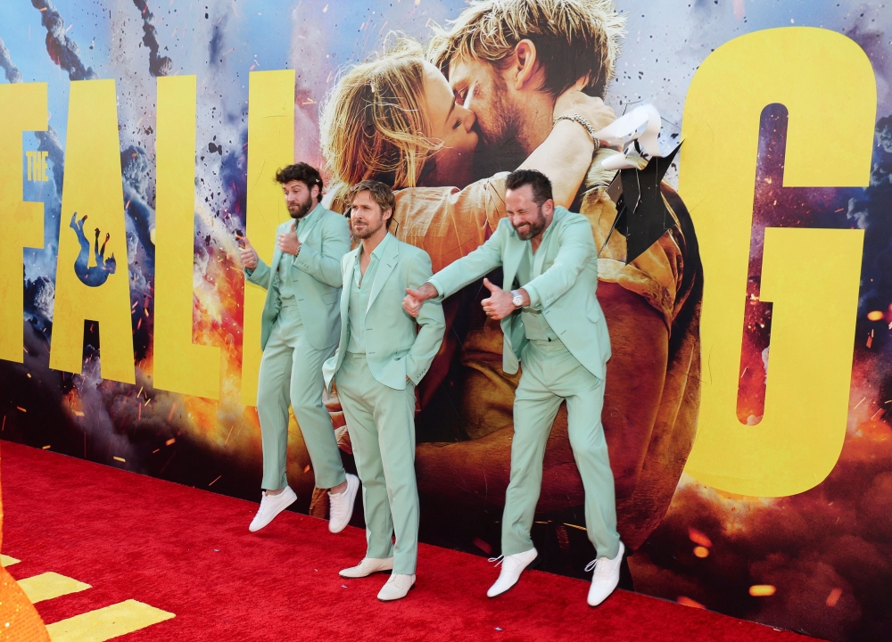 Cast member Ryan Gosling poses for a photo with his stunt doubles while attending a premiere for the film 