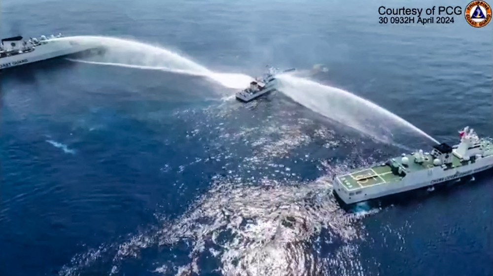 This frame grab from handout video footage taken and released on April 30, 2024 by the Philippine Coast Guard (PCG) shows the Philippine Coast Guard ship BRP Bagacay being hit by water cannon from Chinese coast guard vessels near the chinese-controlled Scarborough shoal in disputed waters of the South China Sea. — AFP / Philippine Coast Guard pic