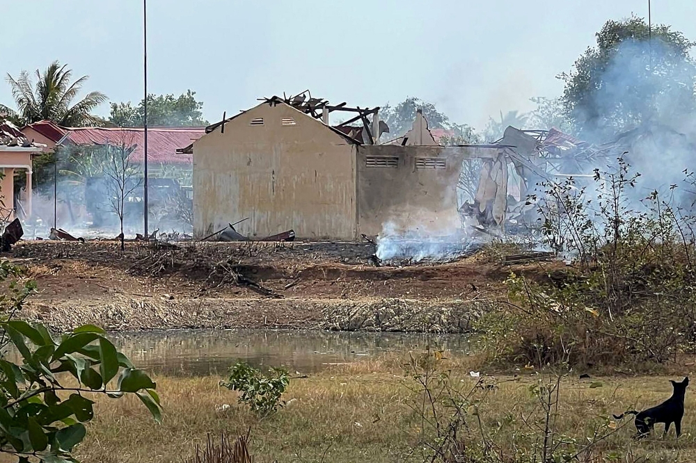 Smoke billows from the warehouse following an explosion at an army base in Kampong Speu province on April 27, 2024. — AFP pic
