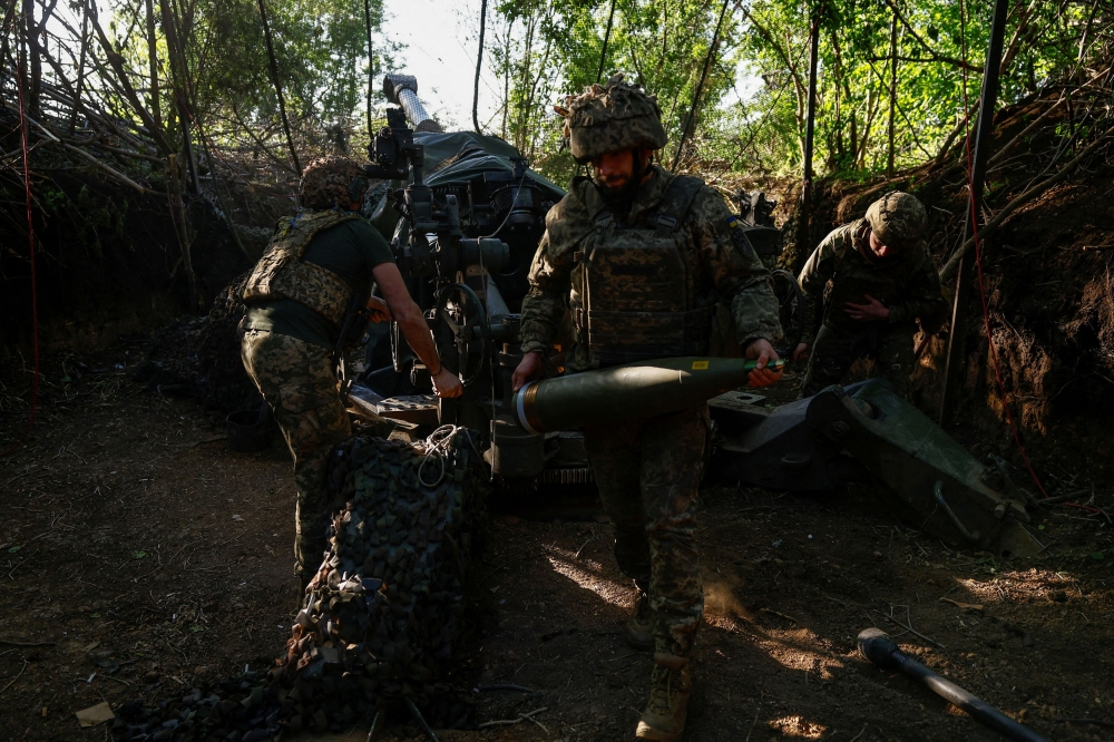 Ukrainian servicemen of the 148th Separate Artillery Brigade of the Ukrainian Air Assault Forces, fire a M777 howitzer toward Russian troops near a front line, amid Russia?s attack on Ukraine, in Donetsk region, Ukraine May 1, 2024. — Reuters pic