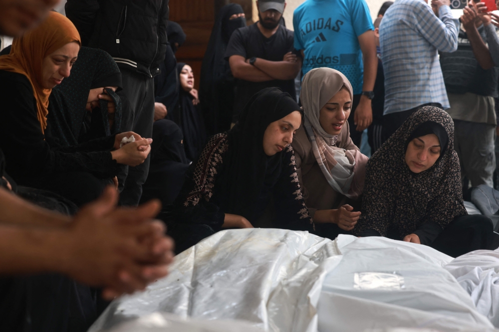 Palestinians mourn loved ones killed in Israeli strikes at the al-Najjar hospital in Rafah. — AFP pic