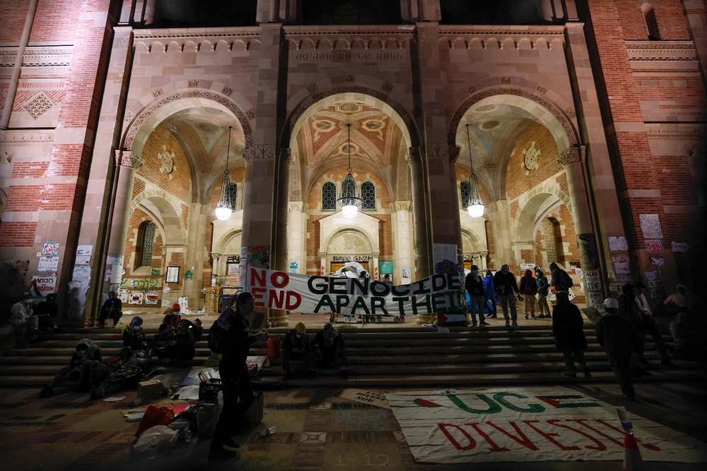 Banners and signs are seen on Royce Hall inside the encampment set up by pro-Palestinian students and activists as they demonstrate on the campus of the University of California, Los Angeles (UCLA) in Los Angeles, California, on May 1, 2024. — AFP pic