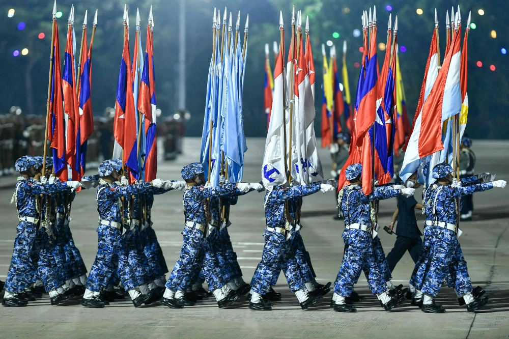 Myanmar junta military soldiers parade during a ceremony to mark the country’s Armed Forces Day in Naypyidaw on March 27, 2024. — AFP pic