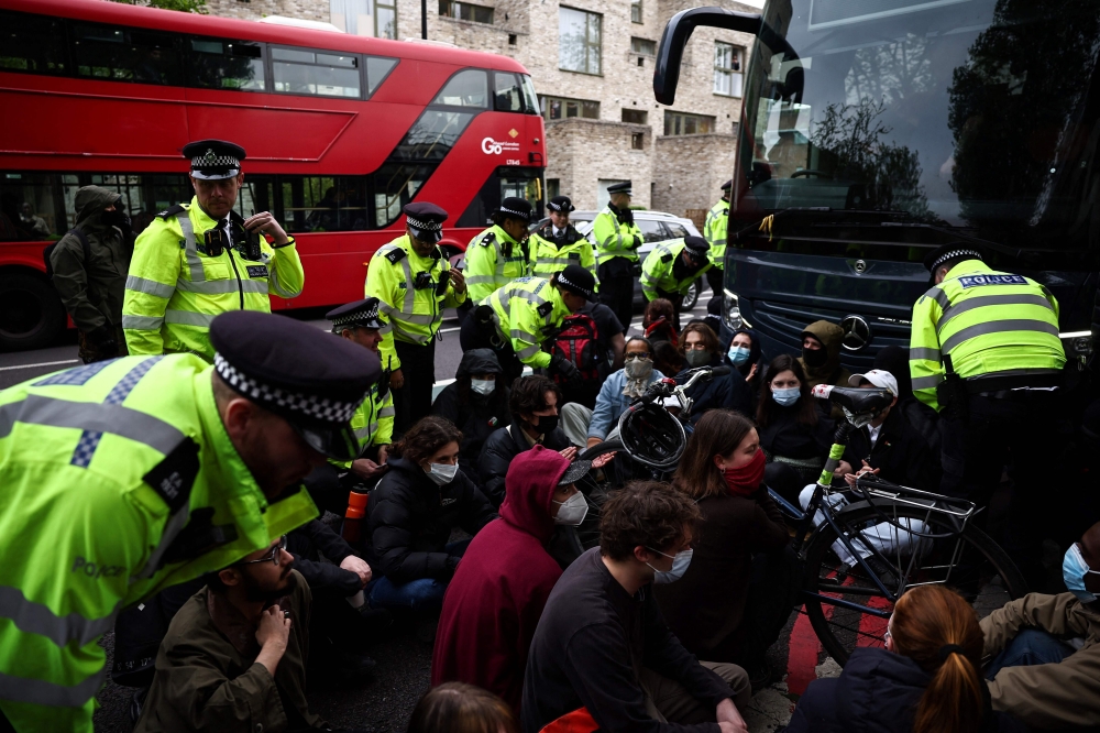 Police in London made 45 arrests yesterday as protesters tried to stop the removal of migrants from their temporary accommodation, after the UK government began detaining people before controversial deportation flights to Rwanda. — AFP pic