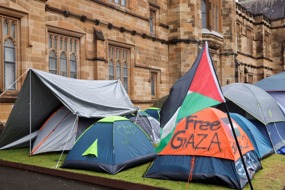 A Palestinian flag flutters next to the protest encampment in support of Palestinians in Gaza at The University of Sydney. — Reuters pic