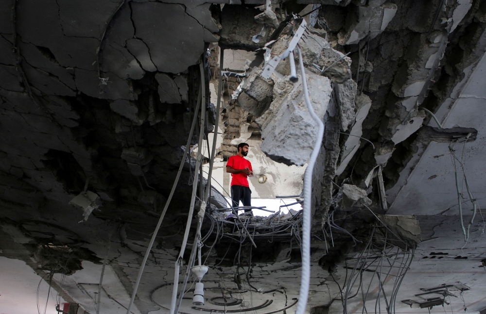 A person stands inside a building, damaged in an Israeli strike, amid the ongoing conflict between Israel and the Palestinian Islamist group Hamas, in Rafah, in the southern Gaza Strip, May 3, 2024. — Reuters pic  