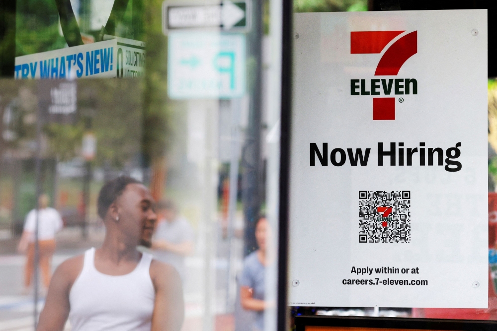 A 7-Eleven convenience store has a sign in the window reading ‘Now Hiring’ in Cambridge, Massachusetts July 8, 2022. — Reuters pic  