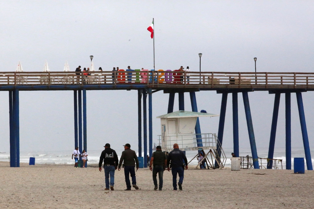 Mexican law enforcement officers walk along the beach, following the disappearance of two Australian tourists and one American tourist in Baja California, in Rosarito, Mexico May 2, 2024. ― Reuters pic