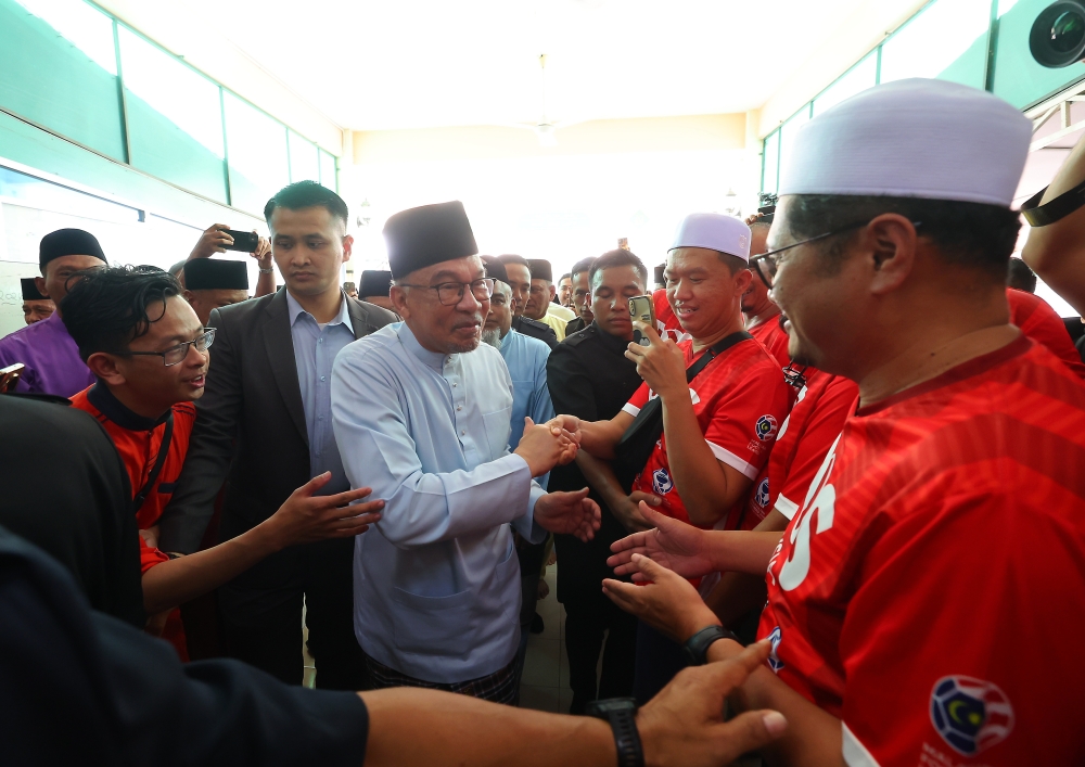 Prime Minister Datuk Seri Anwar Ibrahim (centre) said the projected salary adjustment, estimated to cost over RM10 billion from next year onward, is feasible with disciplined financial oversight. — Bernama pic
