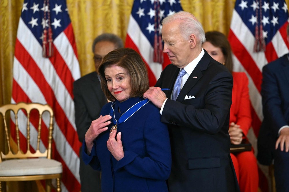 US President Joe Biden presents the Presidential Medal of Freedom to former House speaker Nancy Pelosi in the East Room of the White House in Washington May 3, 2024. ― AFP pic