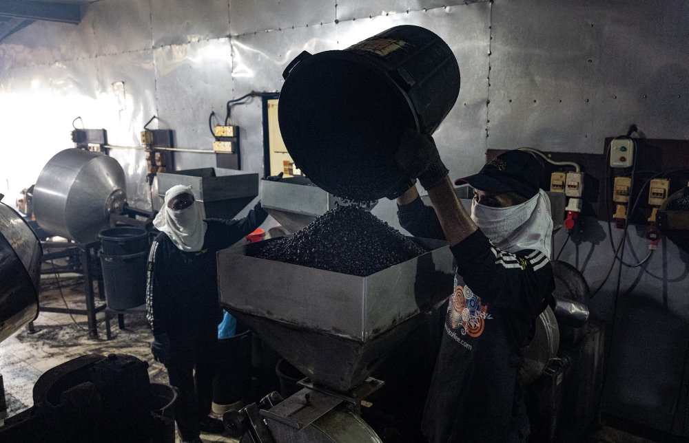 Workers grind coffee beans at Chang Jiang International Sdn Bhd's factory in Ipoh May 4, 2024. — Bernama pic 